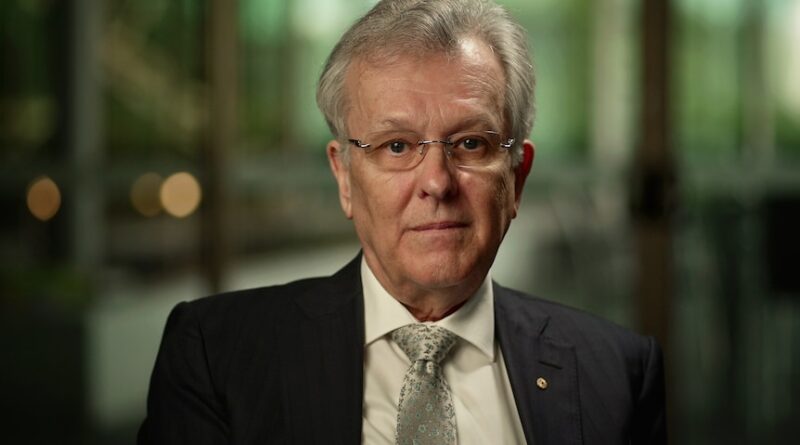 A man in a suit indoors.