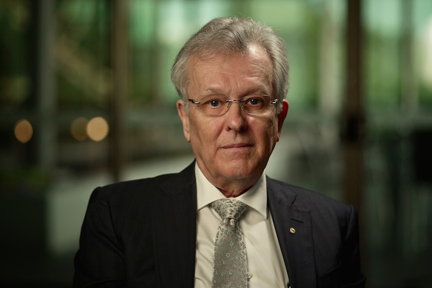 A man in a suit indoors.