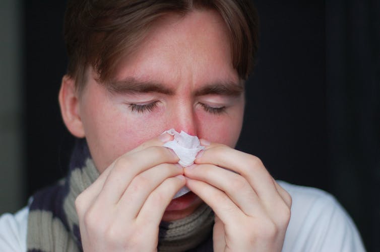 A person blows his nose